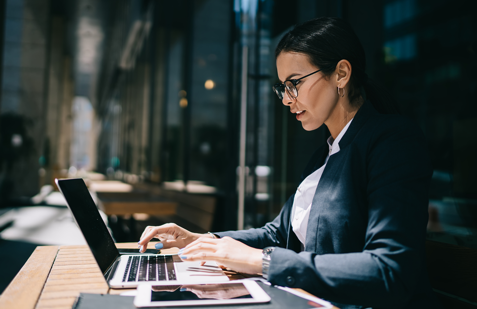 selective focus photography of people sitting on chairs while writing on notebooks